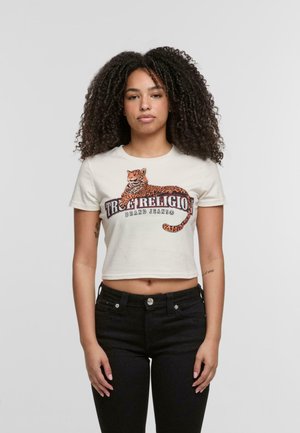 Kruta krem majica s kratkim rukavima s grafikom narančastog i crnog tigra i natpisom "True Religion Brand Jeans." Jednostavna tekstura.