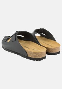 Sandali neri aperti con tomaia in sughero, suola in gomma, caratterizzati da un design ritagliato e cinturini regolabili per una vestibilità sicura.