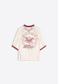 White mesh short-sleeve shirt with red trim, featuring a red horse and rider graphic surrounded by stars and the text "HIGH MAX DESERT".