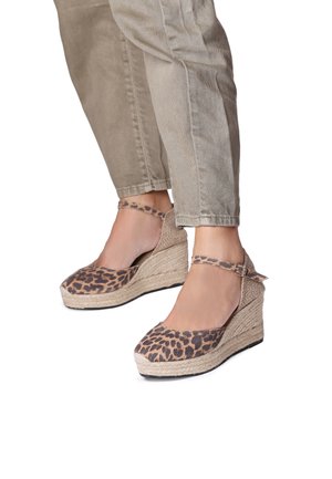 Leopard print wedge sandals with a jute rope sole, ankle strap, and a rounded toe design. Textured fabric with a stable, chunky heel.