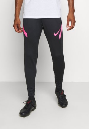 Czarne sportowe spodnie o dopasowanym kroju, z jaskraworóżowymi akcentami logo Nike po bokach, wykonane z elastycznego, odprowadzającego wilgoć materiału.