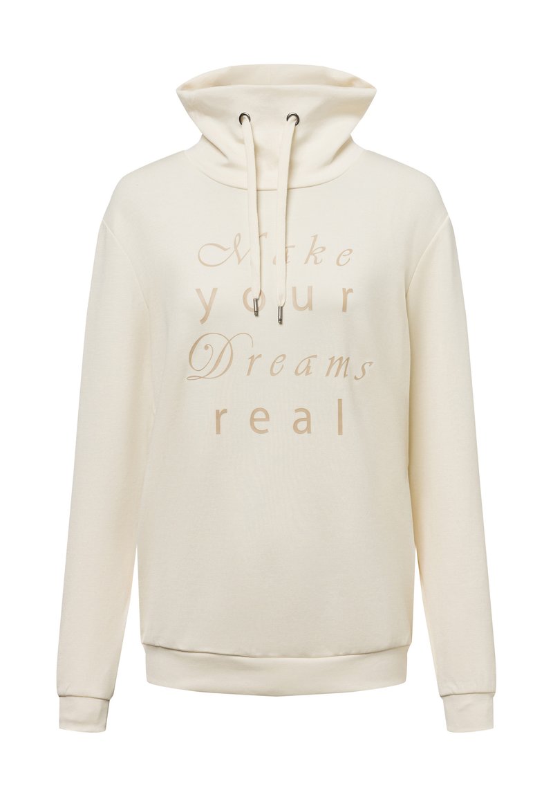 Cream-colored hoodie made of soft fabric, featuring a high collar, drawstring, and the text "Make your Dreams real" in a light font.