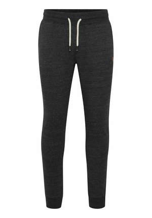 Kohlenstoffgraue Jogginghosen mit schmalem Schnitt, Kordelzugbund, zwei seitlichen Taschen und strukturiertem Stoff. Mit einem dezenten Logo am Oberschenkel.