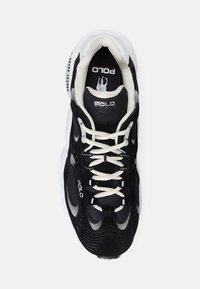 Svart sneakers med vita accenter, texturerat nät och mocka material, med snörningsdesign och "POLO"-branding på tungan.