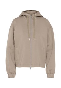 Beige huppari, jossa on vetoketju edessä, suuret taskut ja joustavat hihat. Valmistettu pehmeästä kankaasta, jossa on rento ja ylisuuri istuvuus.