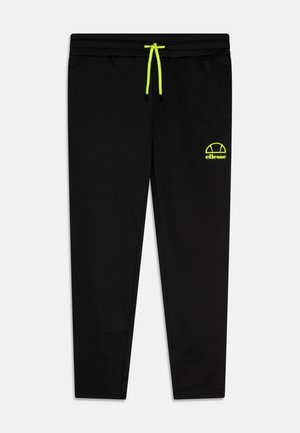 Pantalon de survêtement noir coupe slim avec cordon de serrage jaune néon et petit logo Ellesse jaune néon sur la cuisse gauche.