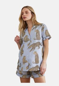Short-sleeve blue pajama set featuring a leopard pattern. The shirt has a button-down front, while the shorts have a matching design.