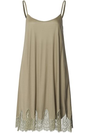 Tan sleeveless dress with a loose fit, featuring a scalloped lace hem in a soft green. Smooth fabric with delicate lace detailing.