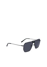 Occhiali da sole in stile black metal con montatura ottagonale, lenti scure e stecche sottili. Presentano un cuscinetto per il naso per il massimo comfort e un branding minimale sulle stecche.