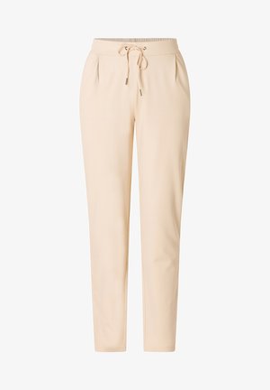 Beige joggingbroek gemaakt van een zachte stof. Voorzien van een trekkoord in de taille, plooien aan de voorkant en taps toelopende benen. Gladde textuur.