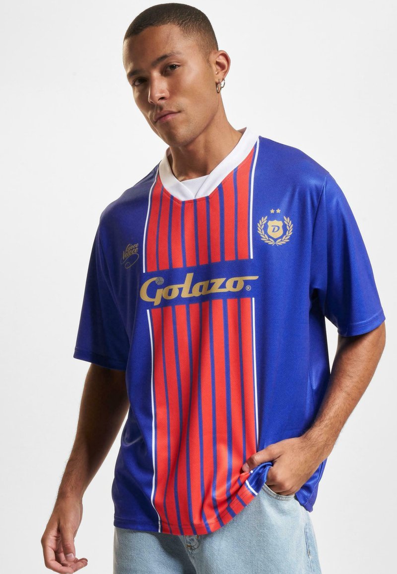 Blue and red vertical striped jersey with white collar and accents, featuring "Golazo" logo in gold, made from a shiny, smooth material.