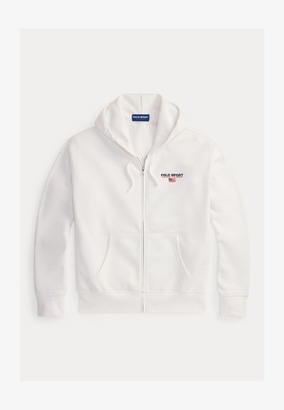 Hoodie blanc à zip en tissu doux, avec une poche frontale, une capuche à cordon de serrage, et un logo brodé "POLO SPORT" sur la poitrine.