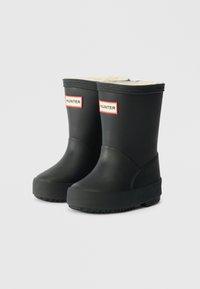 Botas de chuva pretas de borracha com uma sola texturizada, forro peluche e a marca "HUNTER" em vermelho e branco nas laterais. Design curto.