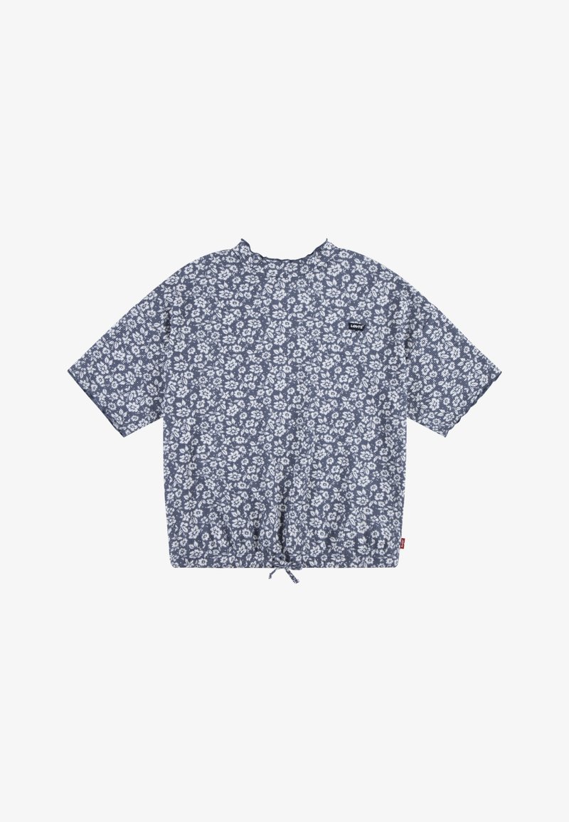 Trumpas rankovės, tamsiai mėlynas gėlių rašto marškinys su apvaliu kaklu, su raišteliu apačioje ir mažu logotipo užspaustu ant krūtinės. Gėlių raštas baltos spalvos.