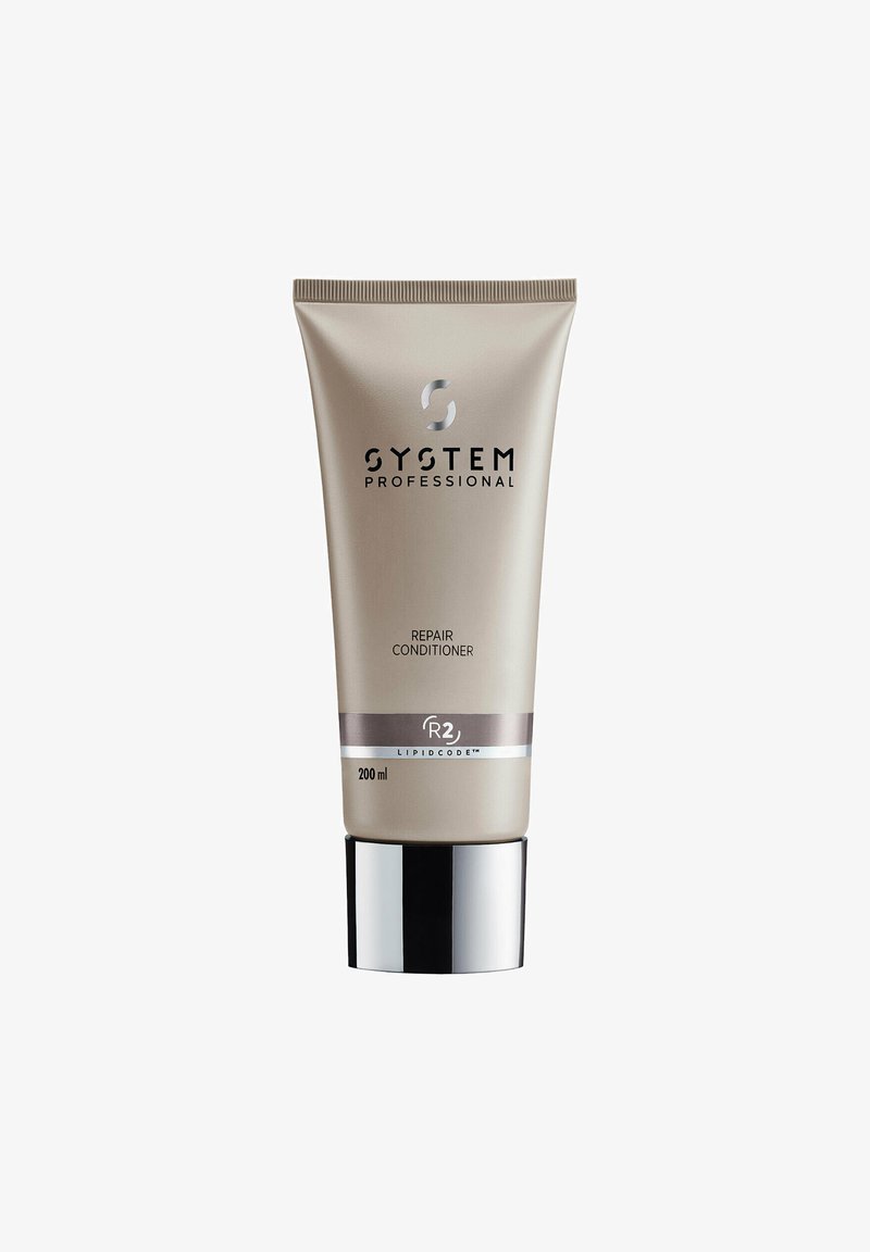 System Professional Repair Conditioner in a metallic beige squeeze tube with a silver band and black text, featuring a black and silver base. 200 ml.