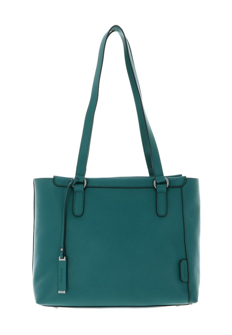 Sac à bandoulière en cuir bleu sarcelle avec deux anses, coutures minimales et une petite étiquette rectangulaire suspendue à une des anses.