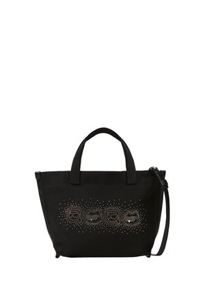Sac cabas noir avec deux anses et une bandoulière amovible, décoré de petits clous métalliques formant des formes abstraites sur le devant.