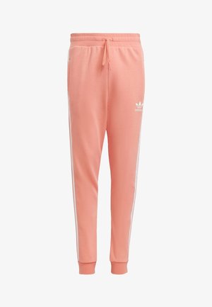 Pink sweatpants made of soft fabric, featuring white side stripes and a drawstring waistband with a logo on the left hip.