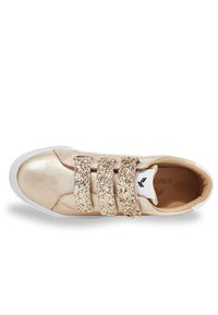 Rose gold sneaker with shiny metallic upper, three glittery Velcro straps, white rubber sole, and textured interior lining.