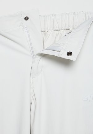 Białe spodnie na elastycznej talii z zamkiem błyskawicznym i zapięciem na zatrzask. Gładka tekstura, z subtelnym logotypem z przodu.