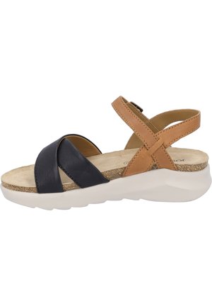 Damen-Sandalen mit schwarzen und tanfarbenen Leder-Riemen, verstellbarem Knöchelverschluss, konturiertem Fußbett und einer leichten weißen Gummisohle.