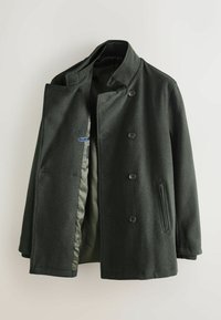 Tmavozelený plstený kabát s dvojradovým zapínaním na gombíky, bočnými vreckami a hladkou vnútornou podšívkou. Elegantný detail goliera.