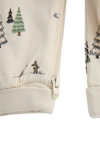 Beige zip-up jacka med tryckta skogs-djur och träd i grönt, mörkgrönt och brunt. Ribbad mudd och mjuk tygtextur.