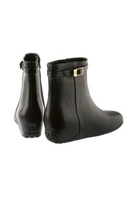 Black leather ankle boots with a smooth finish, rounded toe, and a side zipper. Features a small gold buckle accent on the strap.