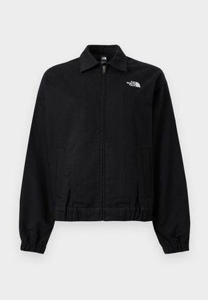 Svart jakke med glidelås, elastiske mansjetter og midjebånd, krage, sidelommer og hvit "The North Face"-logo på øvre venstre bryst.