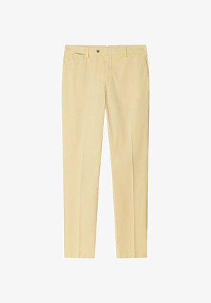 Pantaloni sartoriali giallo chiaro con passanti per cintura, cerniera frontale e tasche laterali, esposti distesi su uno sfondo bianco.