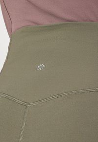 Athleta ELATION FLARE PANT - Leggings - jungle green