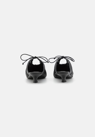 Black leather high-heeled shoes with rounded toe design, gathered texture, and lace-up accents on the heel for adjustable fit.