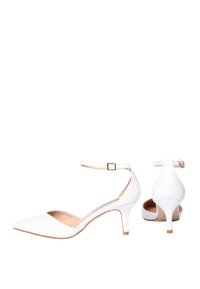 Scarpe con tacco alto bianche, con punta affusolata, cinturino alla caviglia e tacco sottile. Realizzate in materiale liscio con una soletta beige chiaro.