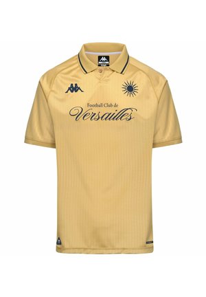 Polo jaune avec le texte « Football Club de Versailles », emblème du soleil, logo Kappa et bordure noire au col.