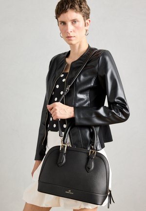 Black structured handbag with dual handles, gold accents, and a smooth texture. The bag features a rounded shape and subtle logo detail.