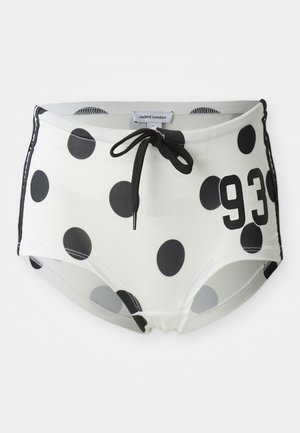 Black and white polka dot swim shorts with a drawstring waistband, featuring the number "93" on the front and a smooth, stretchy fabric.