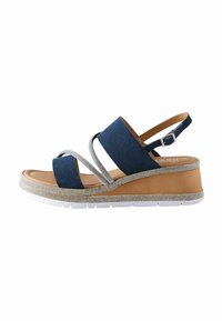 Sandales compensées avec des brides en tissu bleu marine, des accents métalliques argentés et une semelle en caoutchouc blanche. Présente une plateforme texturée et une bride de cheville réglable.