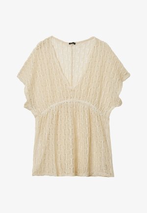 Maglia beige a maniche corte con scollo a V e motivo traforato testurizzato.