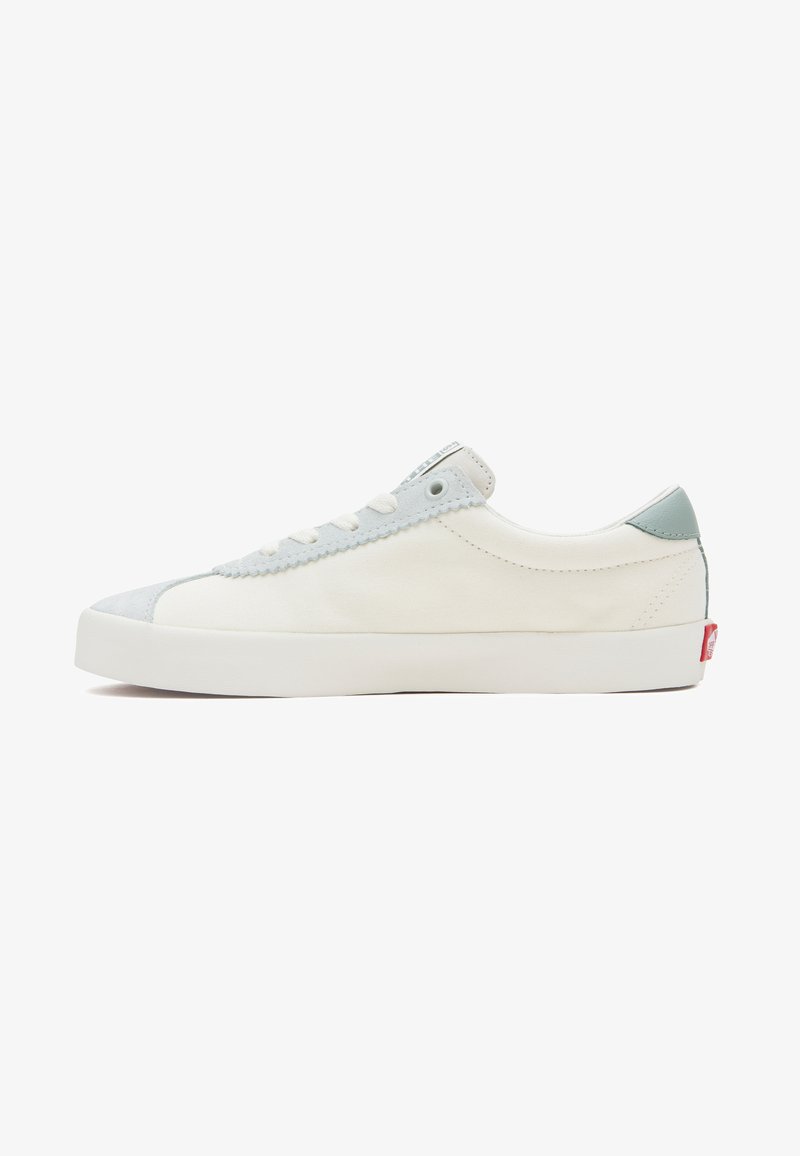 Canvas low-top sneakers in white with light blue accents. Features a rounded toe, white laces, and a rubber sole with a red brand tag.