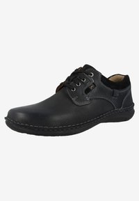 Scarpe in pelle nera con finitura testurizzata, dotate di lacci, cuciture in contrasto e un colletto imbottito per il comfort. Design a profilo basso.