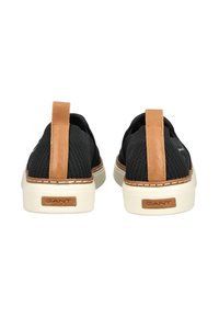 Schwarze Netz-Slipper mit beige Lederabsätzen und cremefarbenen Sohlen. Verfügt über Kontrastnähte und ein Markenlabel auf der Rückseite.