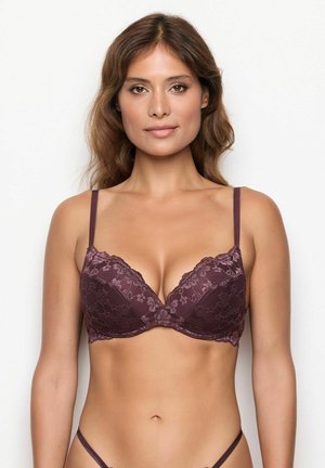 Mauve Spitze-BH mit tiefem Ausschnitt, gepolsterten Cups und verstellbaren Trägern. Mit floralem Spitzenmuster entlang des oberen Randes.