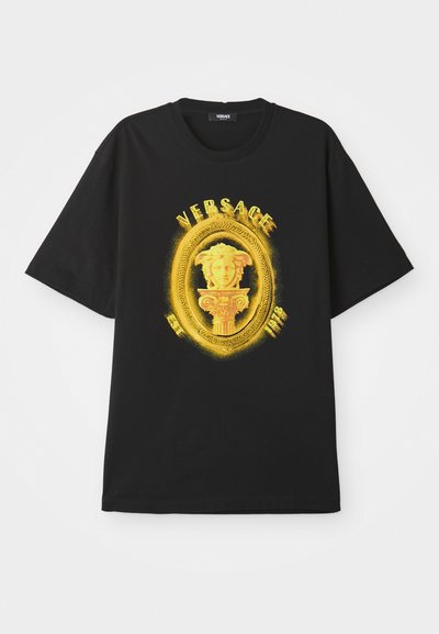 Black short-sleeve t-shirt with yellow ornate oval frame, Medusa head sculpture, and "VERSACE" text on front.