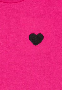 Pink cotton fabric featuring a small black embroidered heart design at the center. The texture is smooth and uniform.