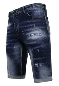 Denim shorts in donkerblauw met versleten plekken en een rafelige zoom. Voorzien van lichtblauwe spetterpatronen en een klassieke vijf-pocket ontwerp.