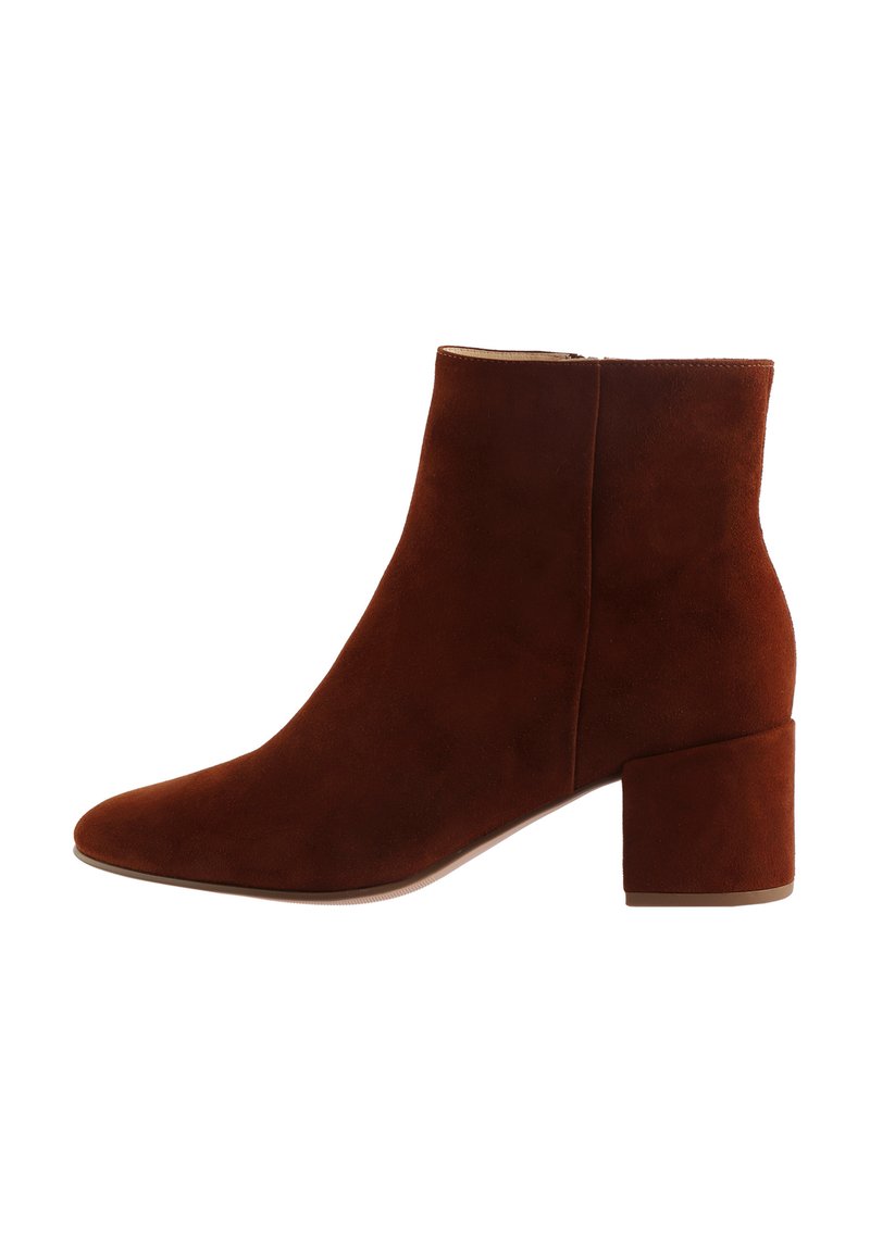 Brown suede ankle boot with a pointed toe, mid-block heel, and smooth texture. Features a sleek side zipper for easy wear.
