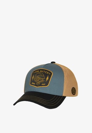 Gorra trucker con parte frontal azul, visera negra y malla trasera en color marrón claro. Presenta un parche redondo con un diseño gráfico y el texto "Von Dutch".