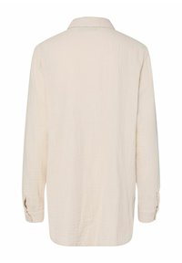 Camicia a maniche lunghe beige chiaro con colletto, realizzata in tessuto Texturizzato, con polsini con bottoni e vestibilità rilassata.