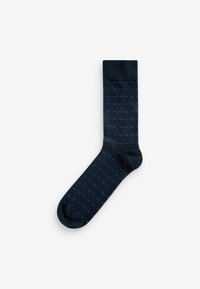 Navy blue sock featuring a ribbed cuff and a pattern of small light blue dots, made from a smooth, stretchy fabric.