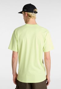 Lys grøn bomulds t-shirt med korte ærmer, rund hals og en glat tekstur; båret med brune cargo shorts, tilbagevisning vist.